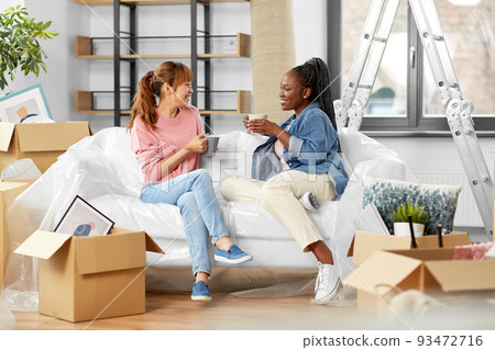 women moving to new home and drinking coffee women moving to new home and drinking coffee 93472716