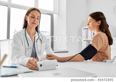 female doctor with tonometer and patient at clinic 93472895