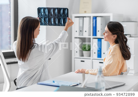 doctor showing x-ray image to woman at hospital doctor showing x-ray image to woman at hospital 93472899