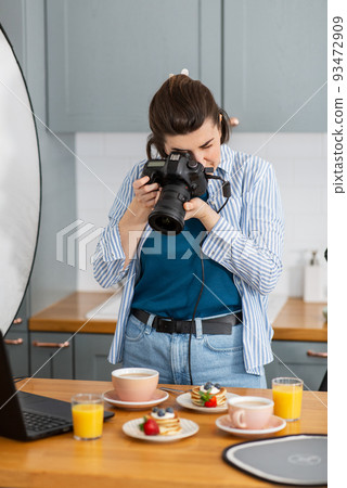 food photographer with camera working in kitchen food photographer with camera working in kitchen 93472909