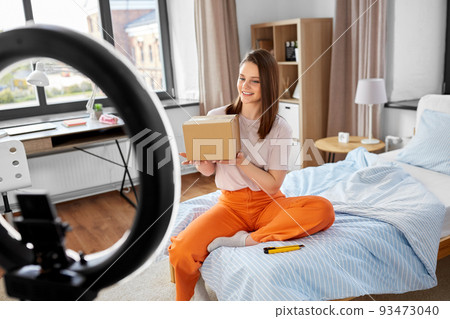 happy girl blogger unpacking parcel box at home happy girl blogger unpacking parcel box at home 93473040