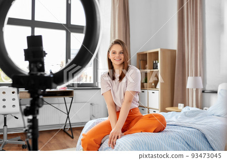 girl blogger with ring light streaming at home 93473045