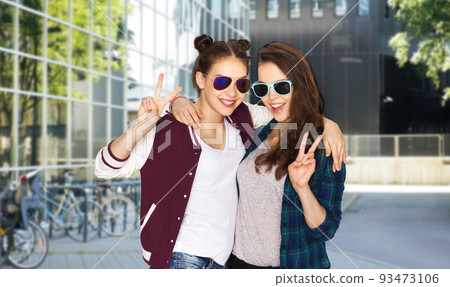 smiling teenage girls in sunglasses showing peace smiling teenage girls in sunglasses showing peace 93473106