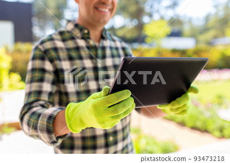 close up of man with tablet pc at summer garden 93473218