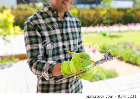 close up of man with clipboard at summer garden close up of man with clipboard at summer garden 93473231