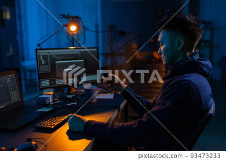 hacker with smartphone and computers in dark room hacker with smartphone and computers in dark room 93473233