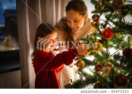 happy family decorating christmas tree at home happy family decorating christmas tree at home 93473323