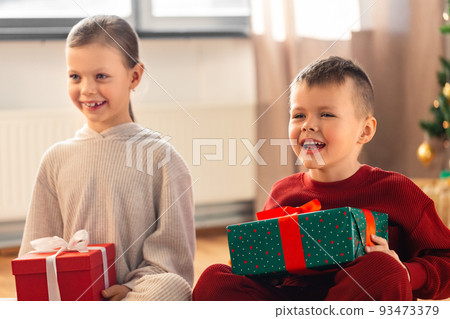 happy children with christmas gifts at home happy children with christmas gifts at home 93473379