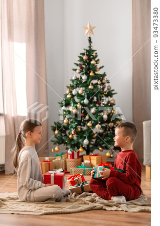 happy children with christmas gifts at home 93473380