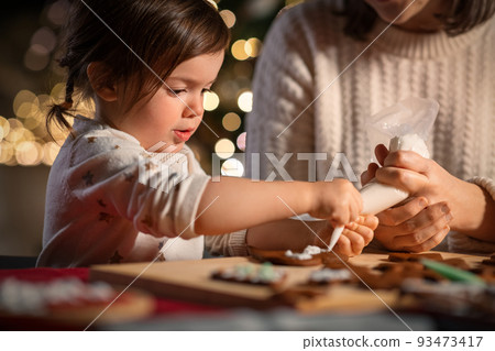mother and daughter decorating gingerbread at home mother and daughter decorating gingerbread at home 93473417