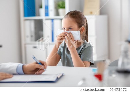 doctor and girl patient blowing nose at clinic 93473472