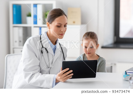 doctor showing tablet pc to little girl at clinic 93473474
