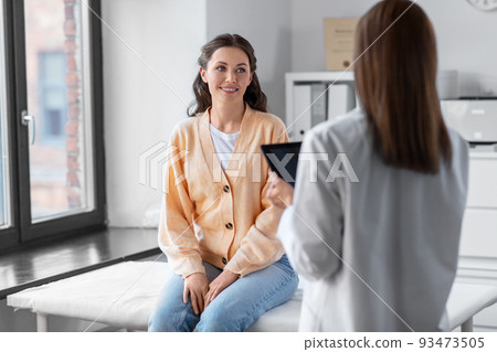female doctor with tablet pc and woman at hospital female doctor with tablet pc and woman at hospital 93473505