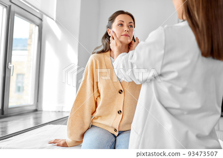 doctor checking lymph nodes of woman at hospital doctor checking lymph nodes of woman at hospital 93473507