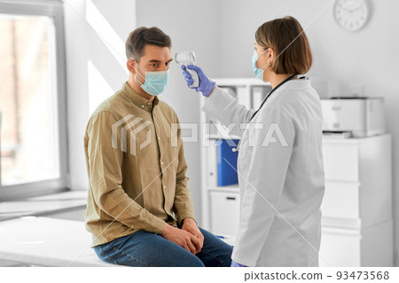 doctor with thermometer and man at hospital doctor with thermometer and man at hospital 93473568