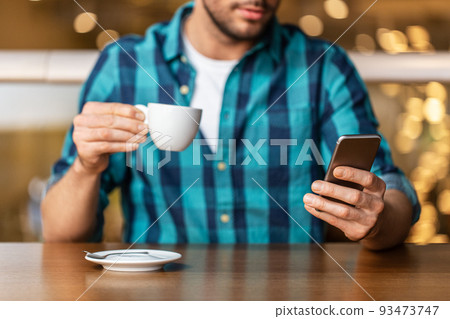 man with coffee and smartphone at restaurant man with coffee and smartphone at restaurant 93473747