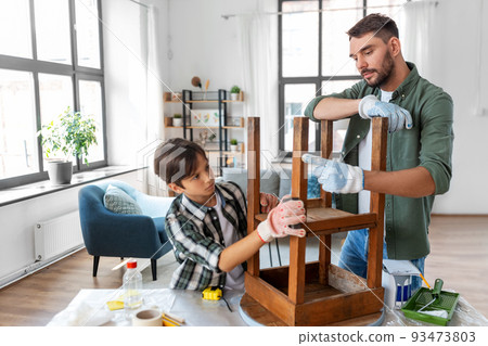 father and son sanding old table with sponge father and son sanding old table with sponge 93473803