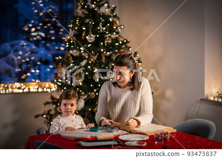 mother and daughter making gingerbread at home mother and daughter making gingerbread at home 93473837