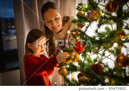 happy family decorating christmas tree at home happy family decorating christmas tree at home 93473903