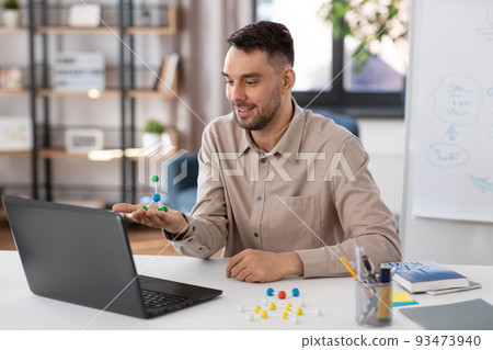 chemistry teacher with laptop having online class 93473940