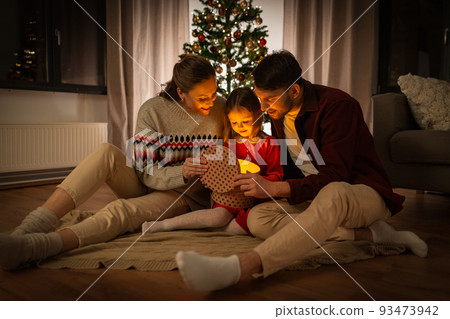 happy family opening christmas gift at home 93473942