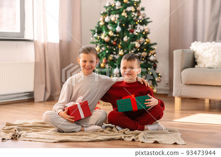 happy children with christmas gifts at home 93473944