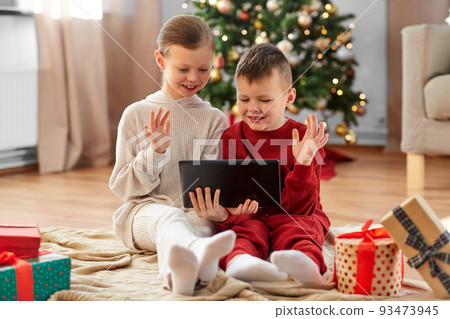 happy children with tablet pc on christmas at home 93473945