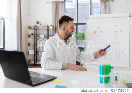 chemistry teacher with laptop having online class 93473965