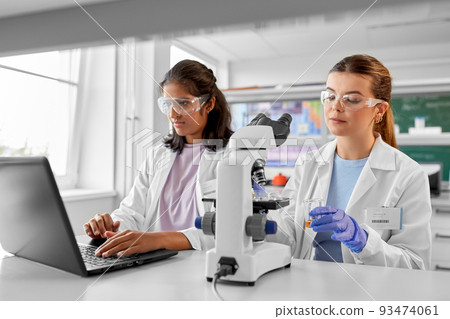 scientists with microscopes working in laboratory 93474061