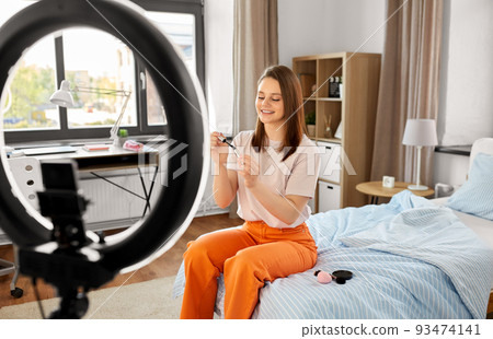 girl blogger with ring light applying make up girl blogger with ring light applying make up 93474141