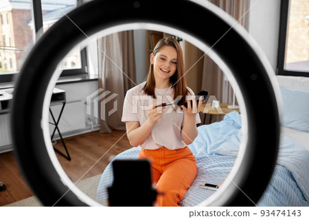 girl blogger with ring light applying make up girl blogger with ring light applying make up 93474143