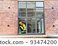 male builder with ruler measuring window 93474200