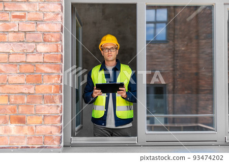 architect in helmet and safety west with tablet pc architect in helmet and safety west with tablet pc 93474202