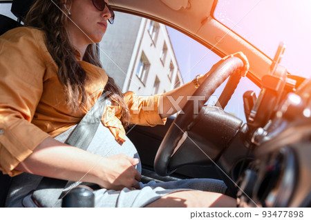 Woman driving car. Beautiful smiling pregnant woman driving car. Safety pregnancy young mother drive concept. 93477898