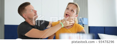 Man jokingly strangles young woman on camera 93478296