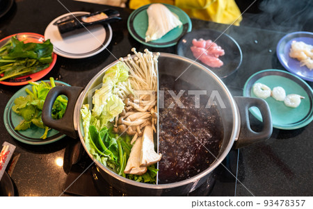 Set of vegetables and meat preparing for eat with hotpot. Hotpot is an interactive meal in which diners sit around a simmering pot of soup at the center of the table with ingredients. Set of vegetables and meat preparing for eat with hotpot. Hotpot is an interactive meal in which diners sit around a simmering pot of soup at the center of the table with ingredients. 93478357