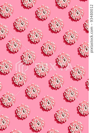 Food design with tasty pink glazed donut on coral pink pastel background top view pattern Food design with tasty pink glazed donut on coral pink pastel background top view pattern 93480012