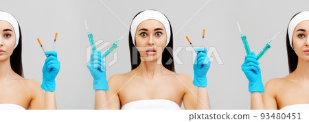 Banner of professional cosmetology. Portraits of a shocked young woman holding syringes in her hands. Gray background. Concept of a victim of plastic surgery Banner of professional cosmetology. Portraits of a shocked young woman holding syringes in her hands. Gray background. Concept of a victim of plastic surgery 93480451