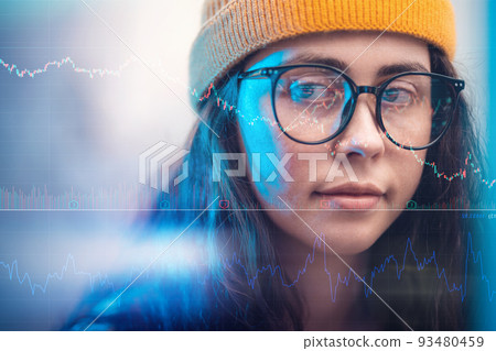 Investments and stock trading. Closeup portrait of a young businesswoman wearing eyeglasses looking at charts and diagrams, double exposure. The concept of analytics, cryptocurrencies and nft Investments and stock trading. Closeup portrait of a young businesswoman wearing eyeglasses looking at charts and diagrams, double exposure. The concept of analytics, cryptocurrencies and nft 93480459
