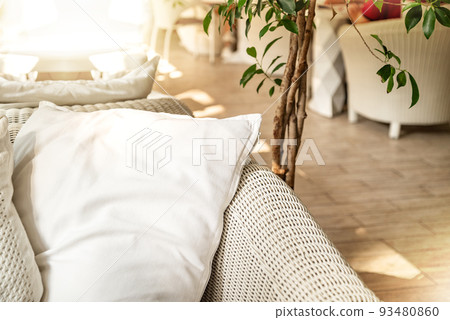 Rattan couch with cushion in boho style patio 93480860