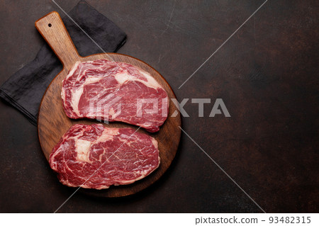 Two raw ribeye beef steaks 93482315