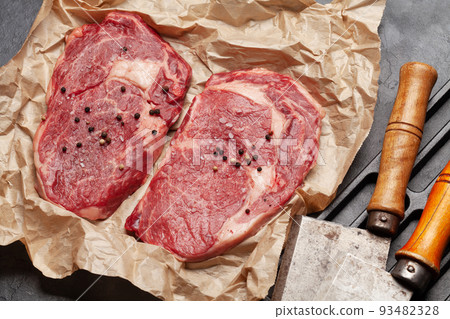Two raw ribeye beef steaks 93482328
