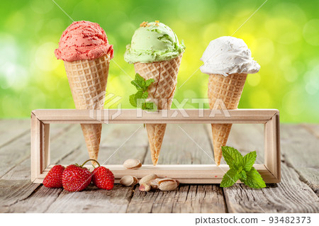 Various ice cream in waffle cones 93482373
