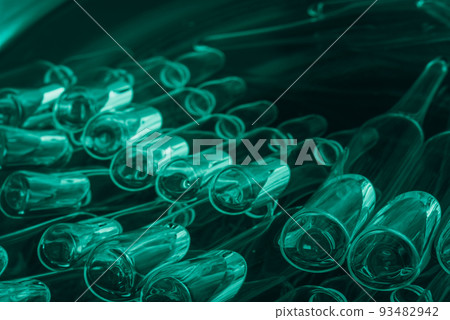 Glass medical ampoule vial for injection. Medicine is liquid sodium chloride with of aqueous solution in ampulla. Close up. Bottles ampule multicolor. 93482942