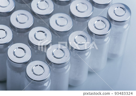 Glass medical ampoule vial for injection. Medicine is dry white drug penicillin powder or liquid with of aqueous solution in ampulla. Close up. Glass medical ampoule vial for injection. Medicine is dry white drug penicillin powder or liquid with of aqueous solution in ampulla. Close up. 93483324
