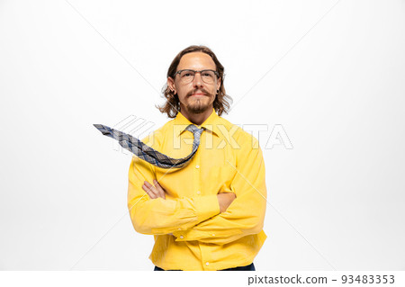 Portrait of young man, office worker in glasses and official shirt posing, looking at camera isolated over white background 93483353