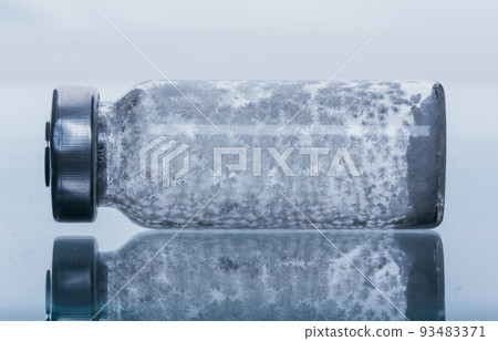 Glass medical ampoule vial for injection. Medicine is dry white drug penicillin powder or liquid with of aqueous solution in ampulla. Close up. Glass medical ampoule vial for injection. Medicine is dry white drug penicillin powder or liquid with of aqueous solution in ampulla. Close up. 93483371