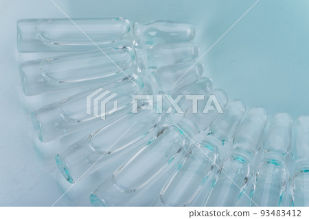 Glass medical ampoule vial for injection. Medicine is dry white drug penicillin powder or liquid with of aqueous solution in ampulla. Close up. Glass medical ampoule vial for injection. Medicine is dry white drug penicillin powder or liquid with of aqueous solution in ampulla. Close up. 93483412