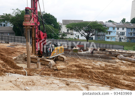 SELANGOR, MALAYSIA -JUNE 30, 2022: Bore pile rig machine at the construction site. The machine used to driven pile for building foundation work. Operated by skilled workers. Heavy machinery. SELANGOR, MALAYSIA -JUNE 30, 2022: Bore pile rig machine at the construction site. The machine used to driven pile for building foundation work. Operated by skilled workers. Heavy machinery. 93483969