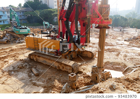 SELANGOR, MALAYSIA -JUNE 30, 2022: Bore pile rig machine at the construction site. The machine used to driven pile for building foundation work. Operated by skilled workers. Heavy machinery. SELANGOR, MALAYSIA -JUNE 30, 2022: Bore pile rig machine at the construction site. The machine used to driven pile for building foundation work. Operated by skilled workers. Heavy machinery. 93483970